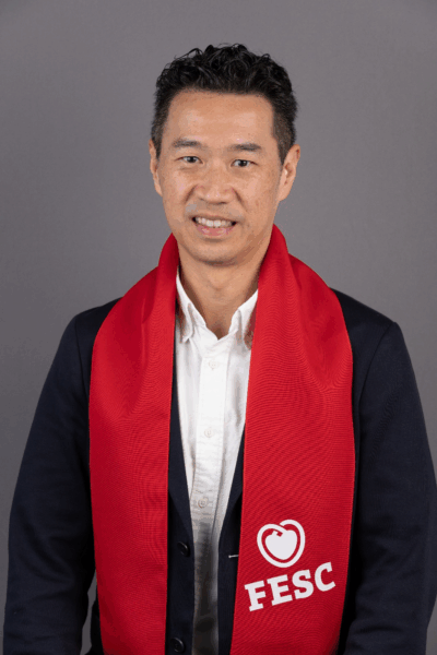 Dr. Joshua Loh at the ESC Congress 2025, Dr. Joshua Loh sitting with a sign with "Guided by Integrity" written at the ESC Congress 2025, Dr. Joshua Loh standing with a sign with "Excellence without Compromise" written at the ESC Congress 2025